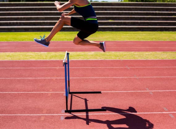 Athlete jumping hurdles