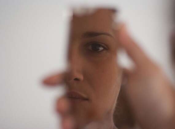 Woman looking into mirror